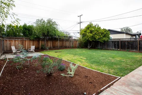 a view of a backyard with a small cabin