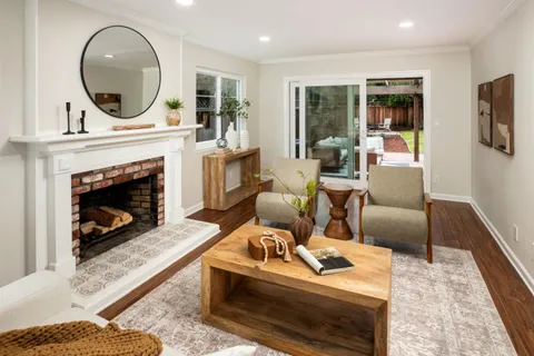a living room with furniture a window and a fireplace