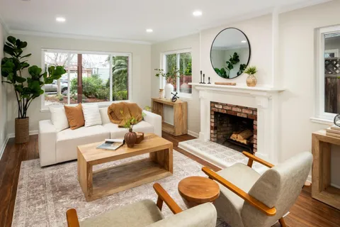 a living room with furniture a window and a fireplace