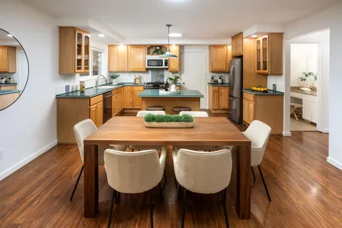 a dining room with furniture and wooden floor