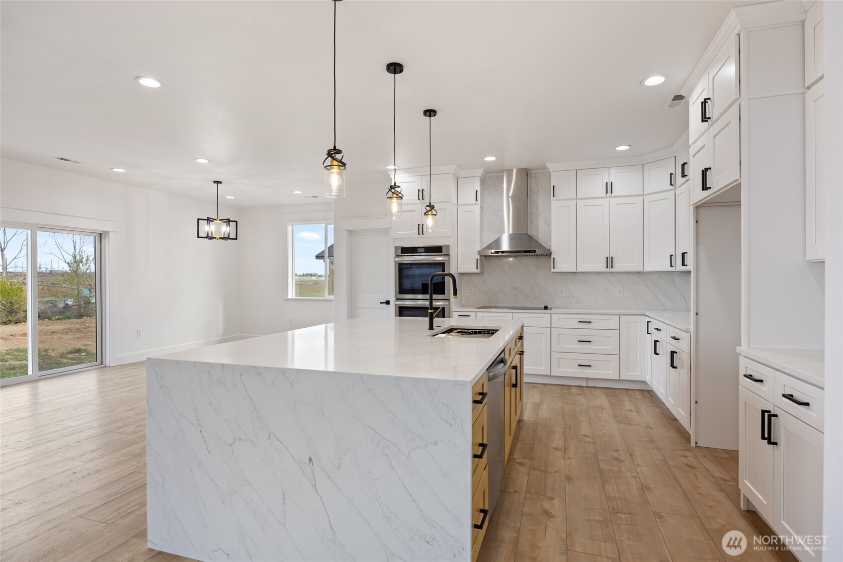 2394 Hunters Street Ephrata, WA 98823 - Photo 12 of 40 a large white kitchen with lots of counter space wooden floor and appliances