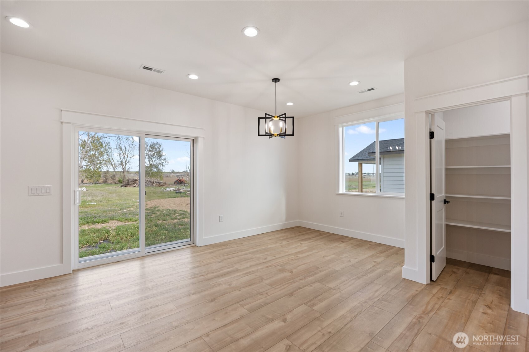 2394 Hunters Street Ephrata, WA 98823 - Photo 15 of 40 an empty room with wooden floor and windows
