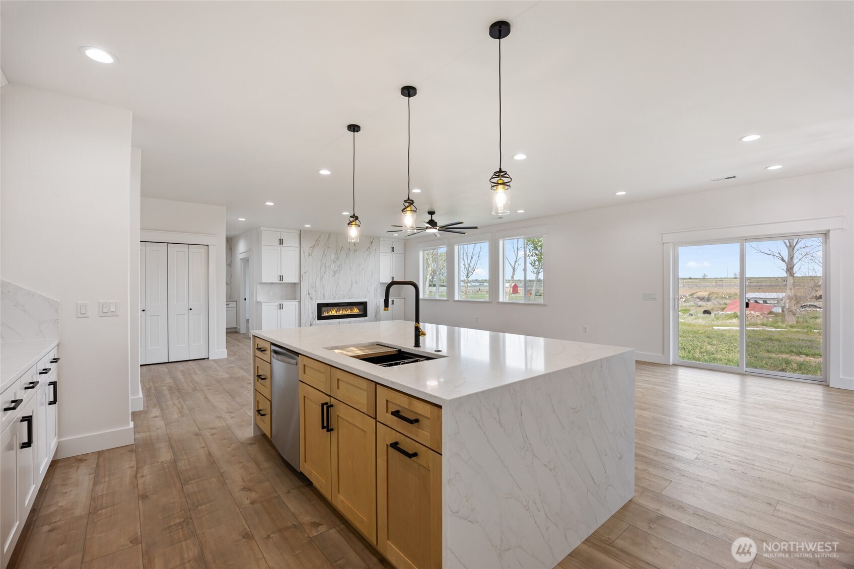2394 Hunters Street Ephrata, WA 98823 - Photo 8 of 40 a large kitchen with kitchen island a large counter top a sink stainless steel appliances and cabinets