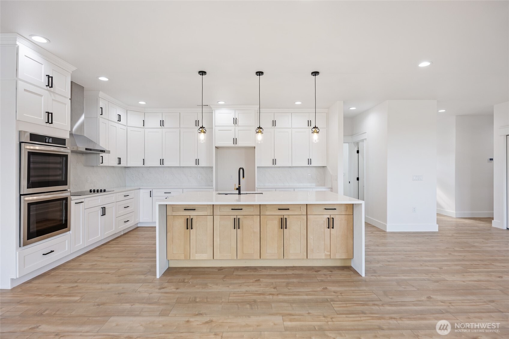 2394 Hunters Street Ephrata, WA 98823 - Photo 10 of 40 a large white kitchen with stainless steel appliances granite countertop a stove a sink a refrigerator and white cabinets with wooden floor