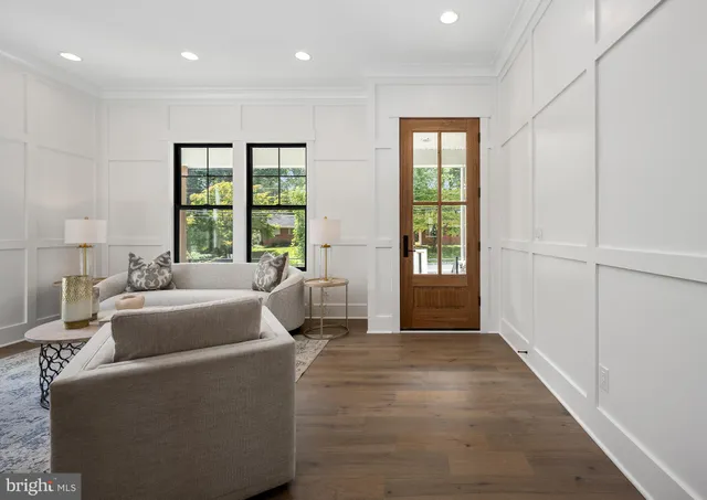 a kitchen with white cabinets and a window
