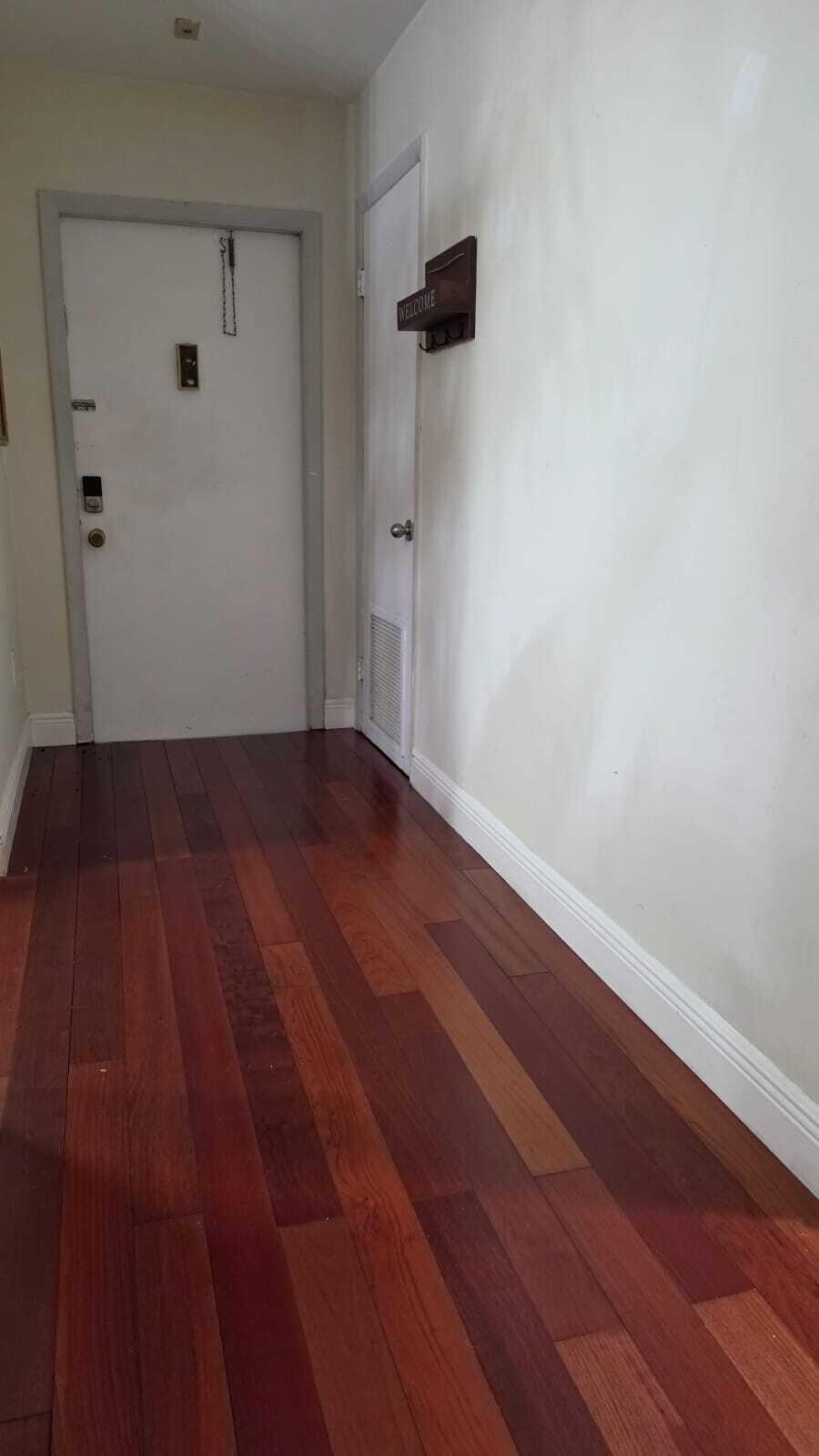 100 Ashbury Road, Unit 206 Hollywood, FL 33024 - Photo 3 of 23 a view of room with wooden floor and white walls