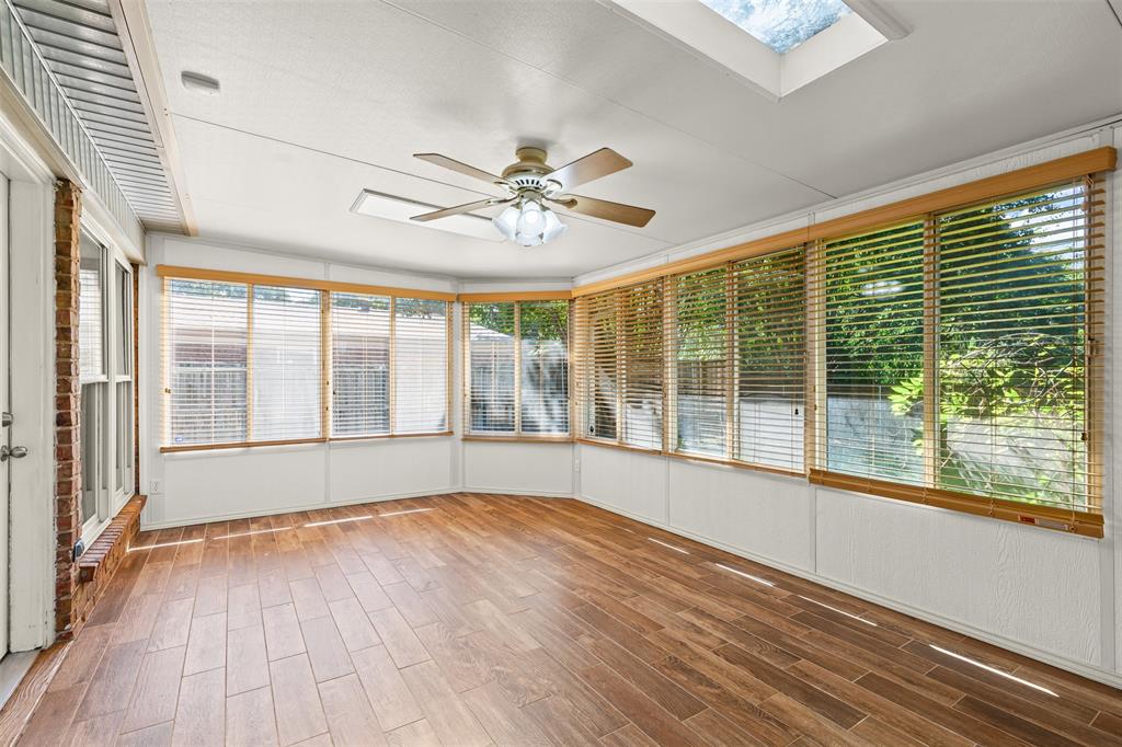 1013 Mockingbird Drive Grapevine, TX 76051 - Photo 16 of 26 a view of an empty room with a window and wooden floor