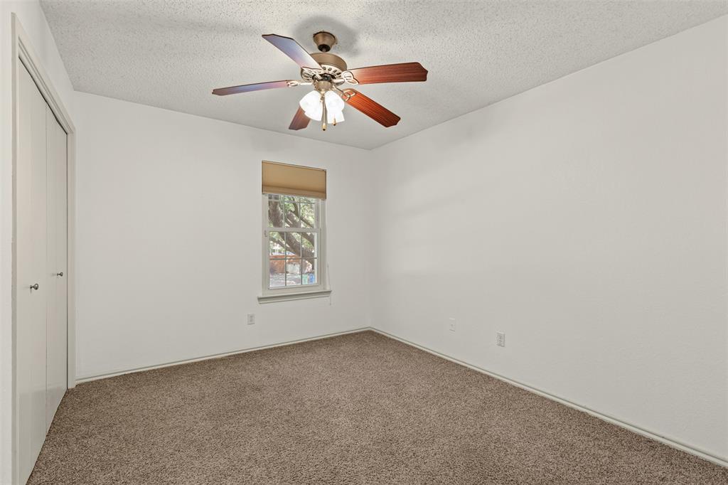 1013 Mockingbird Drive Grapevine, TX 76051 - Photo 22 of 26 an empty room with a window and a fan