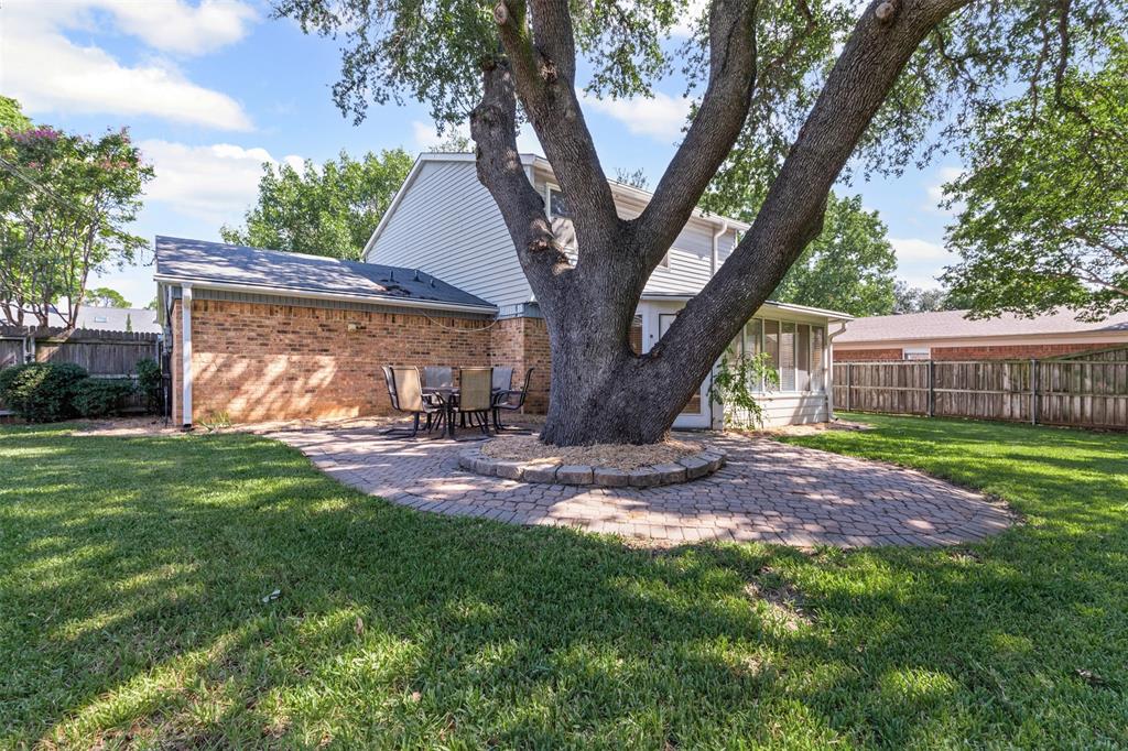 1013 Mockingbird Drive Grapevine, TX 76051 - Photo 25 of 26 a view of a backyard with a tree