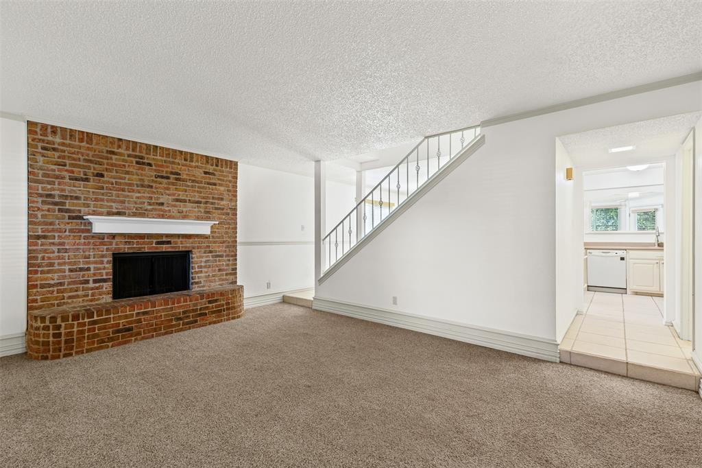 1013 Mockingbird Drive Grapevine, TX 76051 - Photo 5 of 26 a view of an empty room with a fireplace and a window