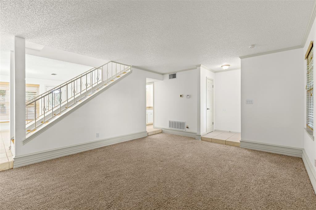 1013 Mockingbird Drive Grapevine, TX 76051 - Photo 8 of 26 a view of an empty room with stairs