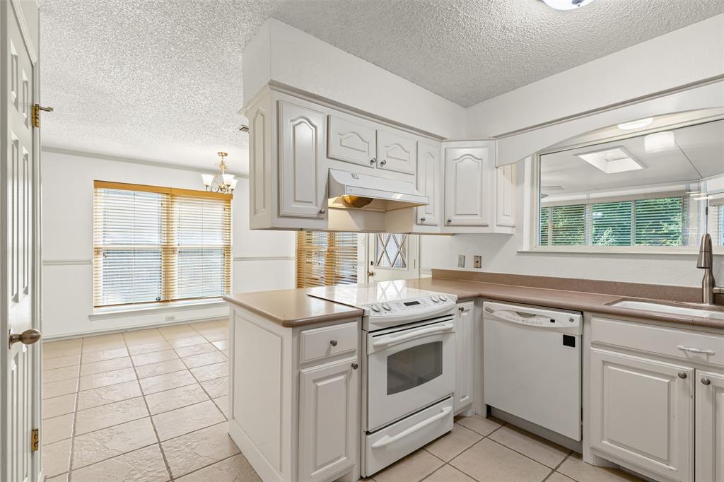 1013 Mockingbird Drive Grapevine, TX 76051 - Photo 10 of 26 a kitchen that has a sink and a stove
