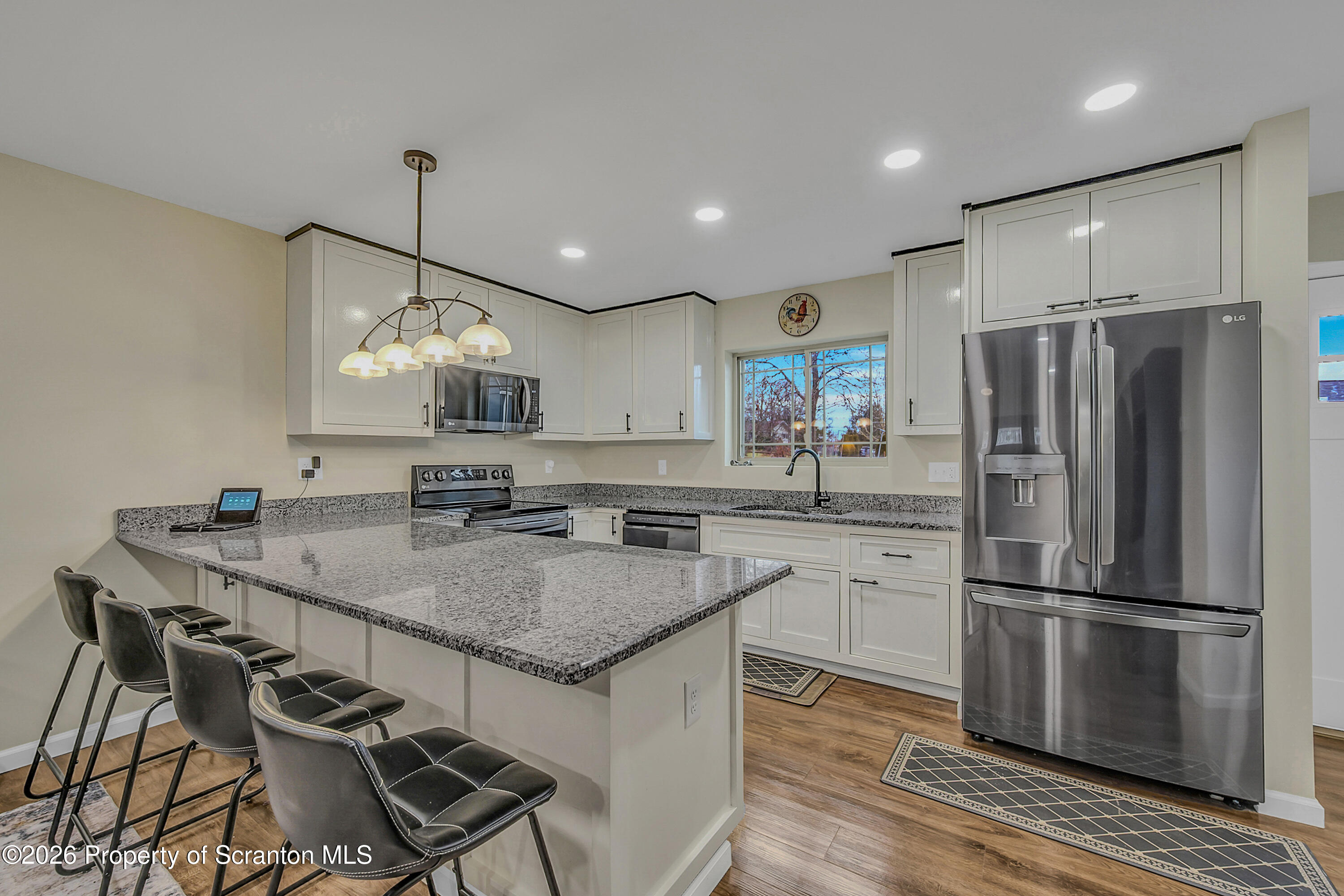 8 Hermel Street Scott Township, PA 18447 - Photo 16 of 38 a kitchen with a refrigerator a sink and chairs