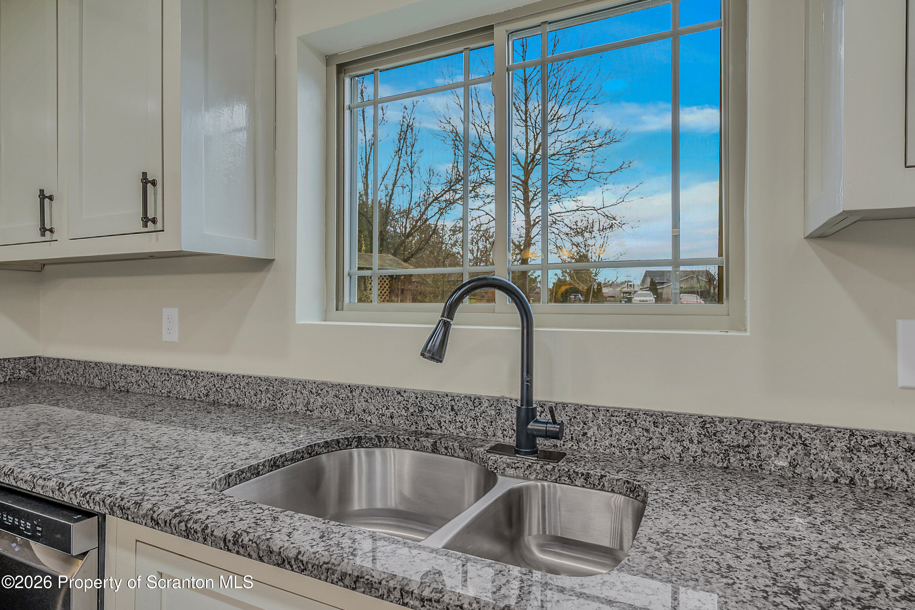 8 Hermel Street Scott Township, PA 18447 - Photo 18 of 38 a kitchen with granite countertop a sink and a window