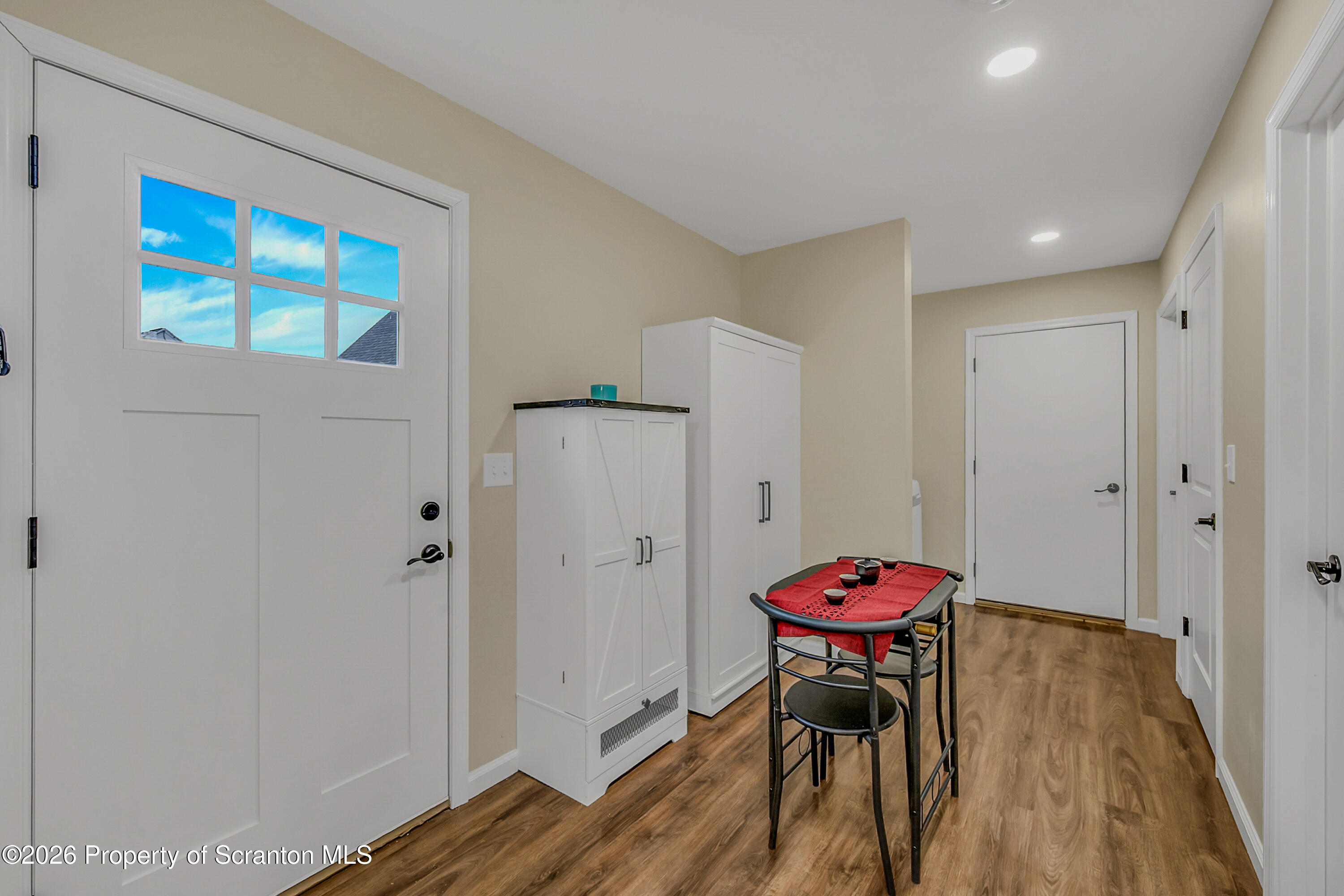 8 Hermel Street Scott Township, PA 18447 - Photo 31 of 38 a hallway with a dining table chairs and wooden floor