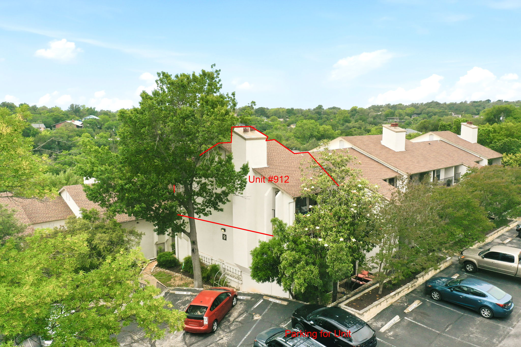 6910 Hart Lane, Unit 912 Austin, TX 78731 - Photo 29 of 36 Multi-level structure featuring light-colored stucco exterior walls and a brown shingle roof
