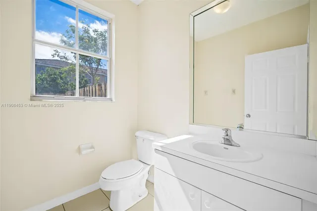a bathroom with a sink toilet and a mirror