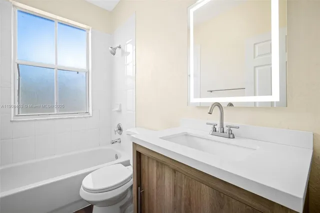 a bathroom with a sink toilet vanity and shower