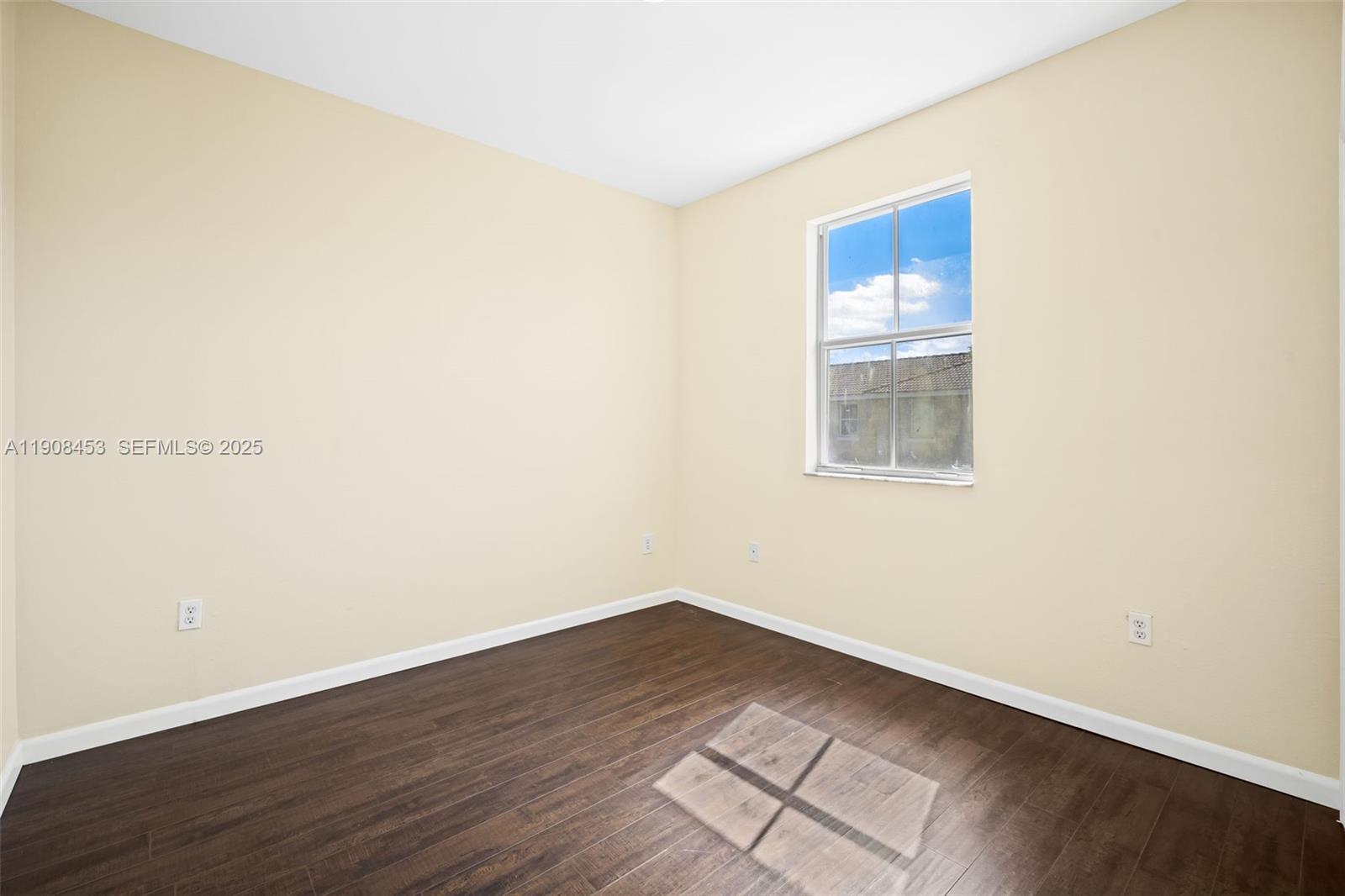13834 Southwest 274th Terrace Homestead, FL 33032 - Photo 15 of 26 an empty room with wooden floor and windows