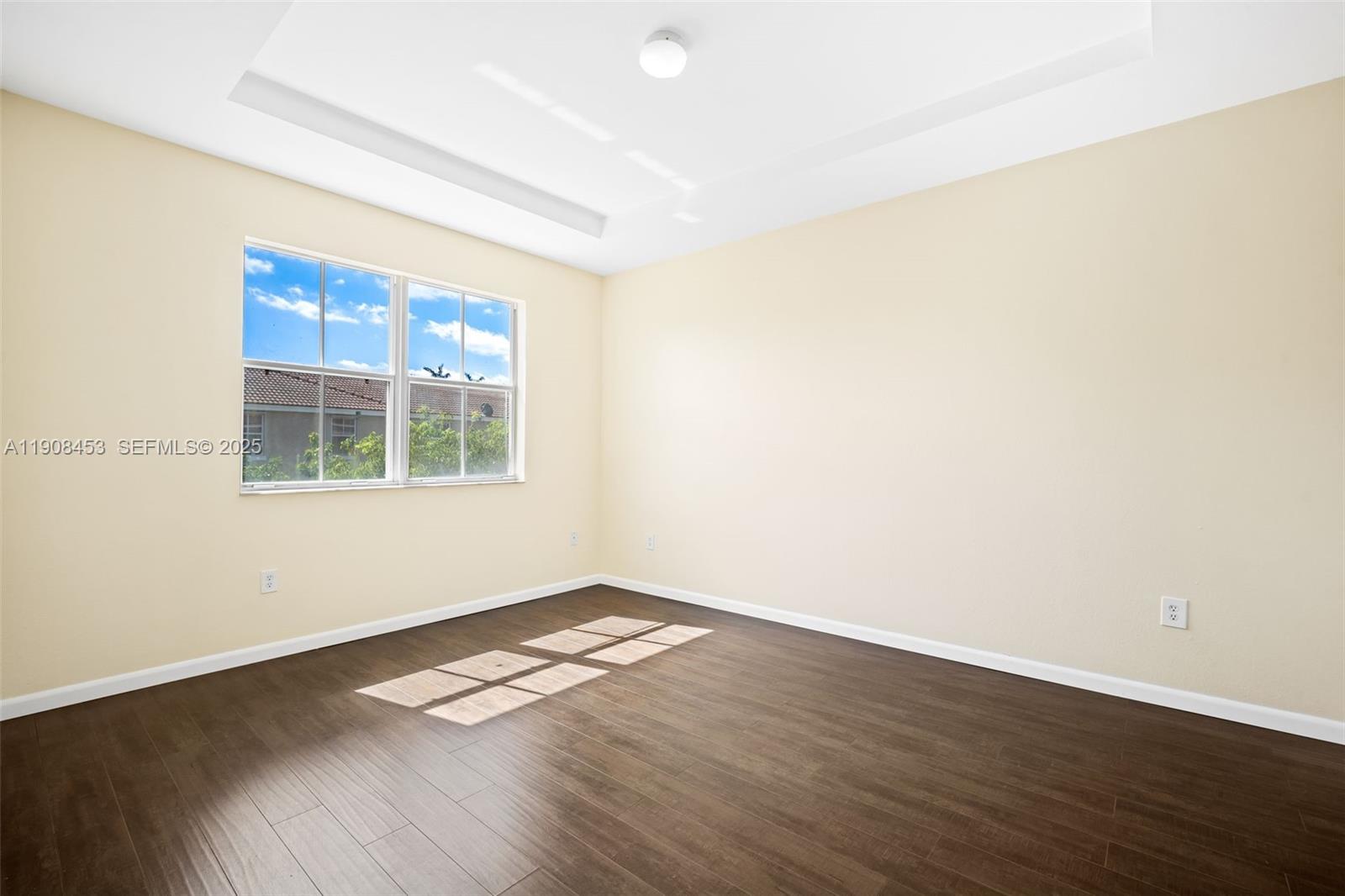 13834 Southwest 274th Terrace Homestead, FL 33032 - Photo 17 of 26 an empty room with wooden floor and windows