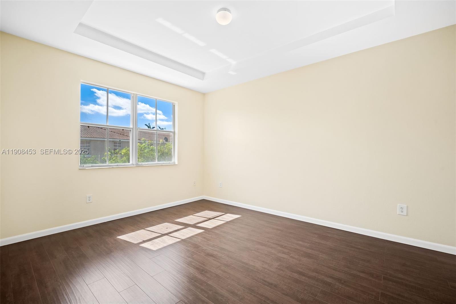 13834 Southwest 274th Terrace Homestead, FL 33032 - Photo 21 of 26 an empty room with wooden floor and windows