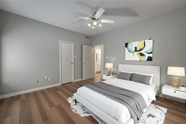 a bedroom with bed and a chandelier