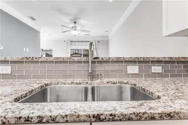 a view of a kitchen with a sink and microwave