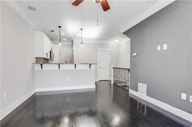 a view of a kitchen with a sink and wooden floor