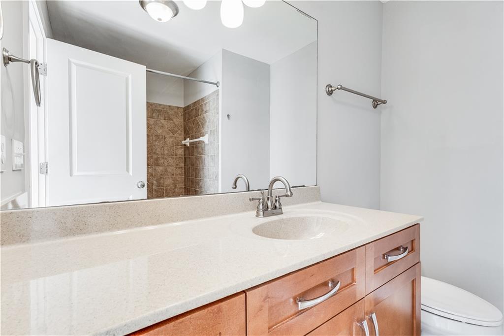 216 Semel Circle Northwest, Unit 355 Atlanta, GA 30309 - Photo 23 of 48 a bathroom with a sink a toilet and a mirror