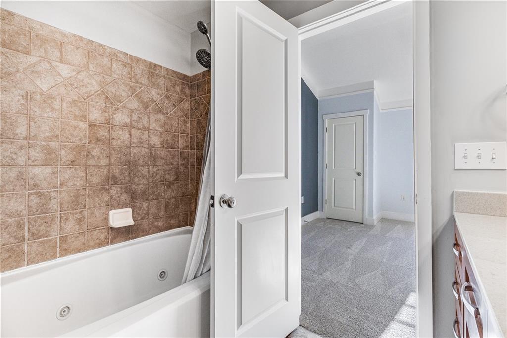 216 Semel Circle Northwest, Unit 355 Atlanta, GA 30309 - Photo 24 of 48 a bathroom with a bathtub and a shower