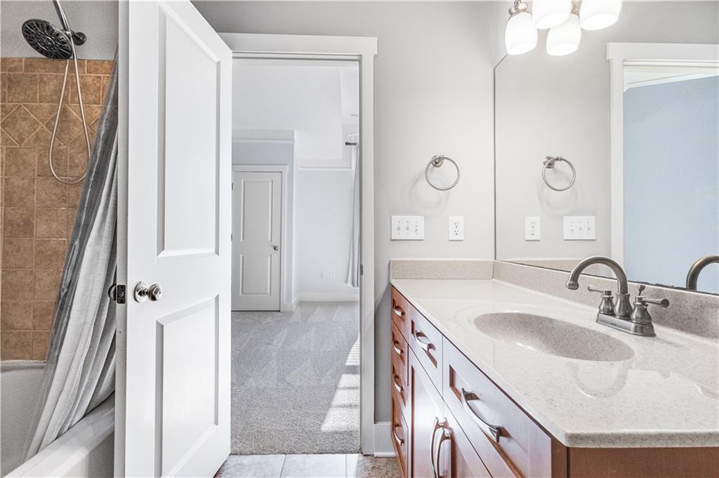 216 Semel Circle Northwest, Unit 355 Atlanta, GA 30309 - Photo 25 of 48 a bathroom with a sink vanity granite tub shower and a mirror