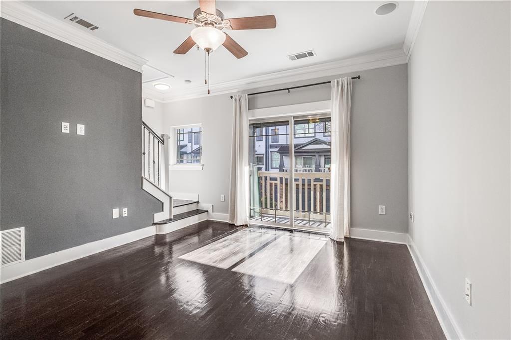 216 Semel Circle Northwest, Unit 355 Atlanta, GA 30309 - Photo 6 of 48 a view of a livingroom with wooden floor and a ceiling fan