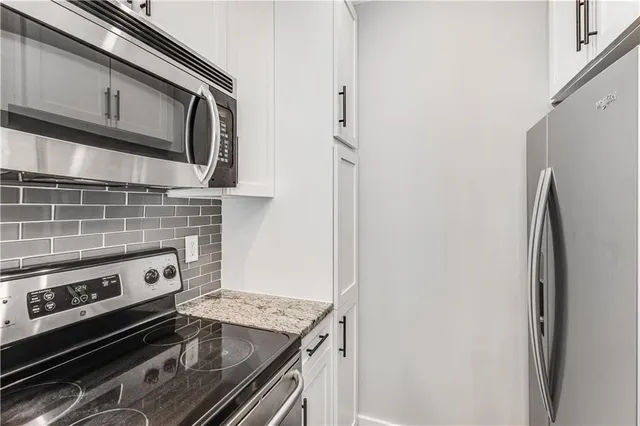 a kitchen with a stove microwave and refrigerator