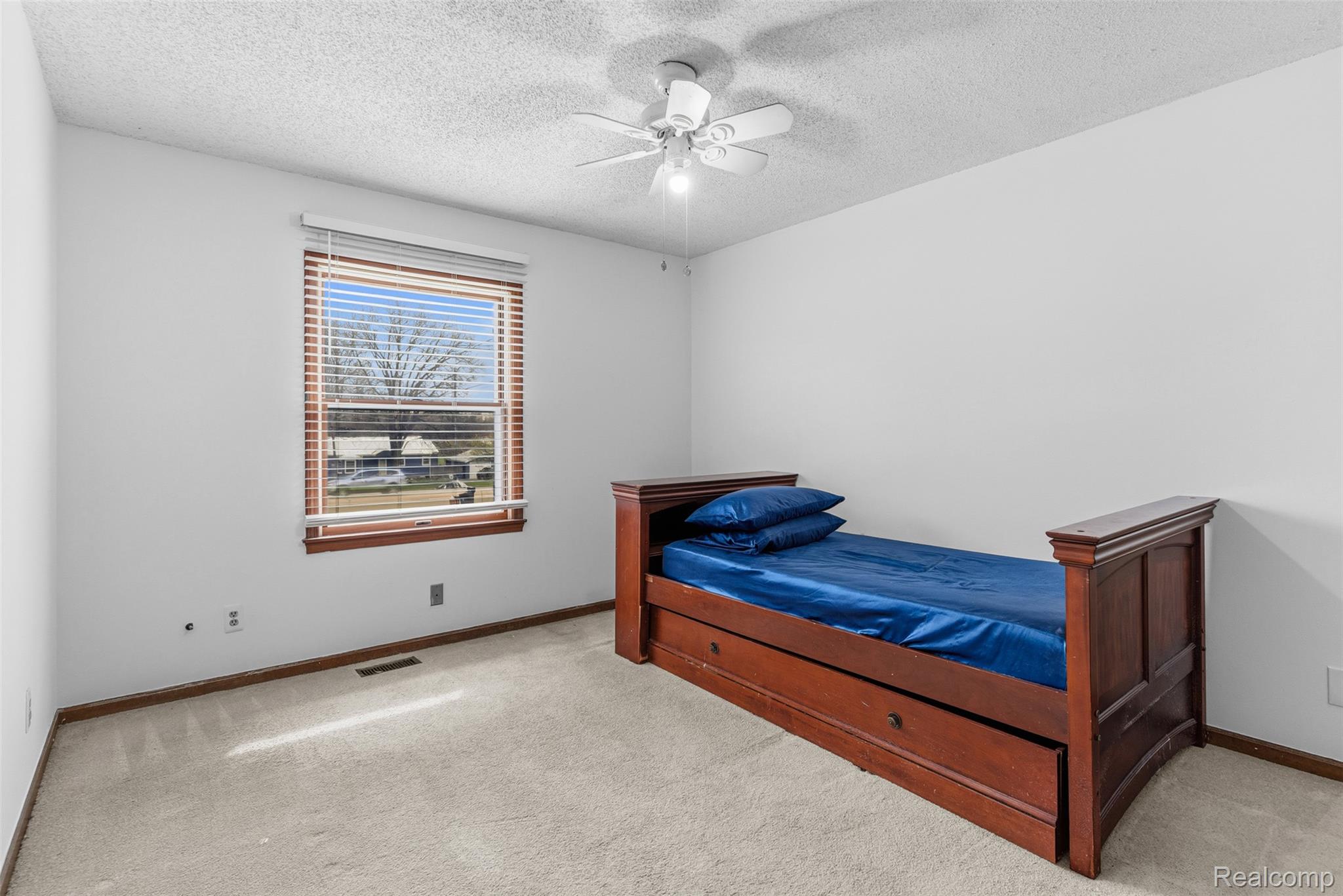 3432 South State Road Davison, MI 48423 - Photo 22 of 58 Bedroom with light carpet, a textured ceiling, and ceiling fan