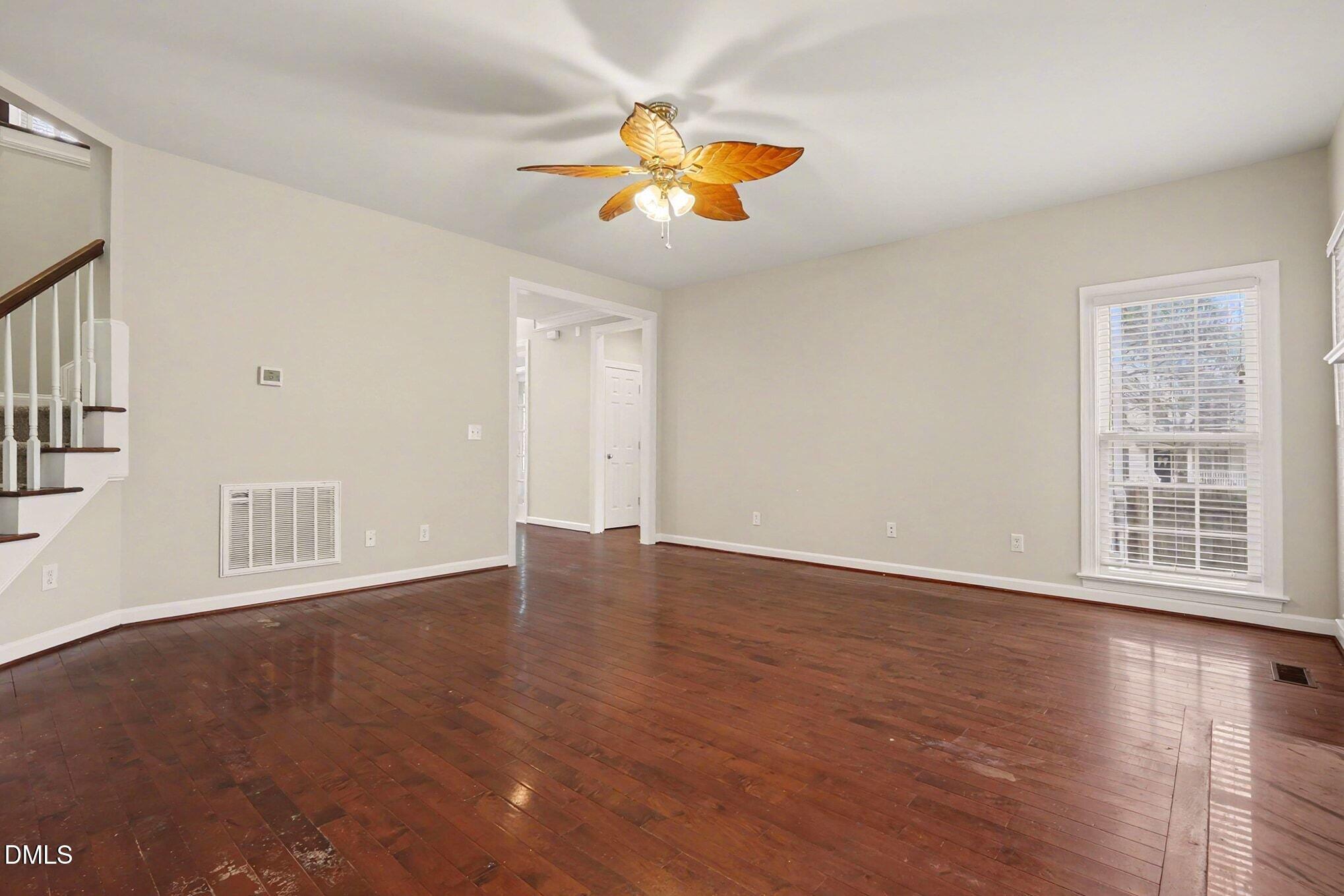 6101 Tiffield Way Wake Forest, NC 27587 - Photo 11 of 40 a view of an empty room with wooden floor and a window
