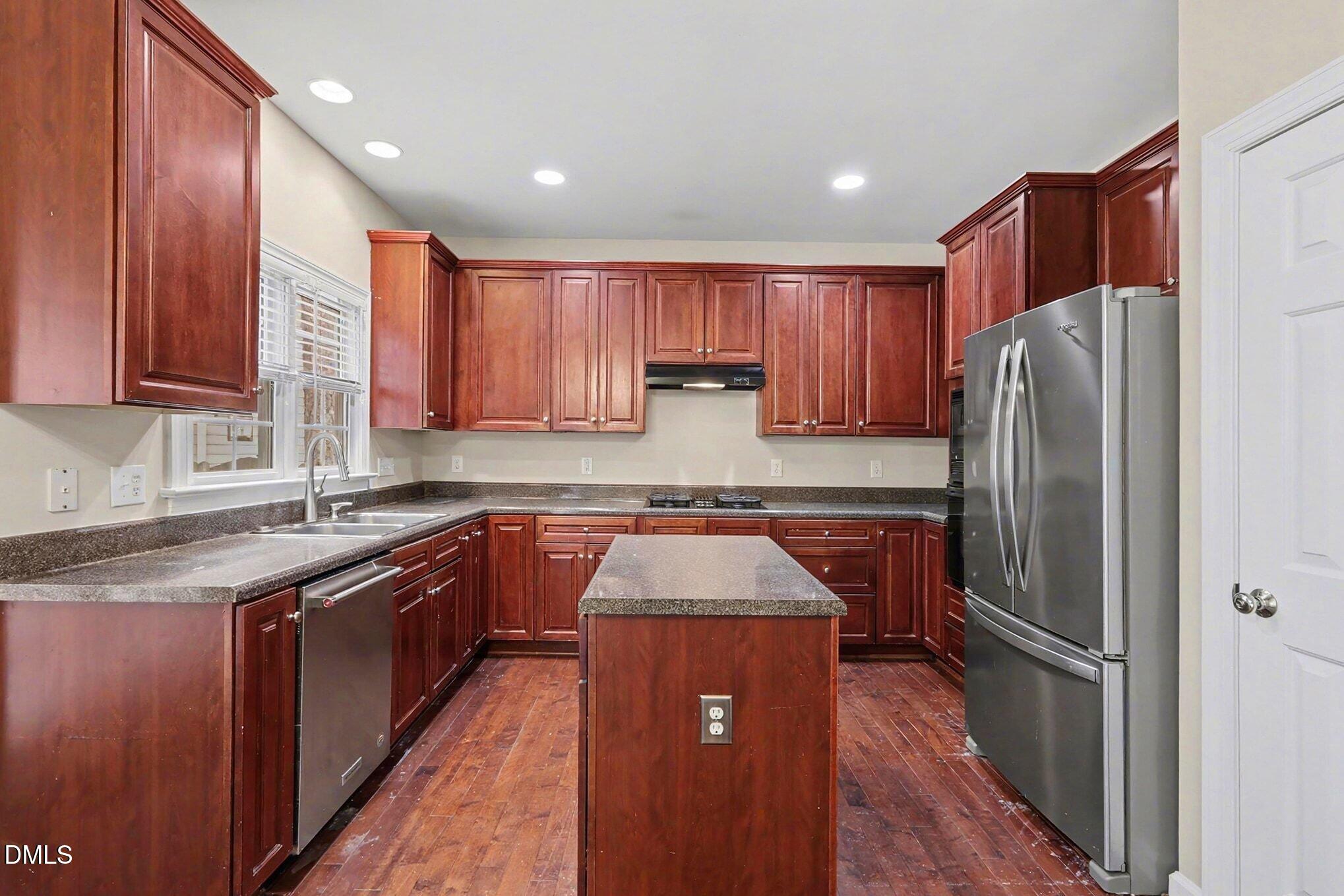 6101 Tiffield Way Wake Forest, NC 27587 - Photo 13 of 40 a kitchen with stainless steel appliances granite countertop refrigerator sink and cabinets