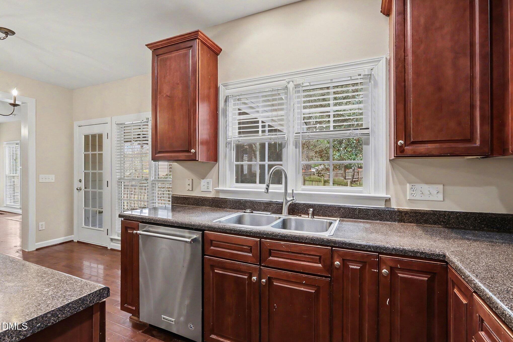 6101 Tiffield Way Wake Forest, NC 27587 - Photo 15 of 40 a kitchen with granite countertop cabinets sink and window