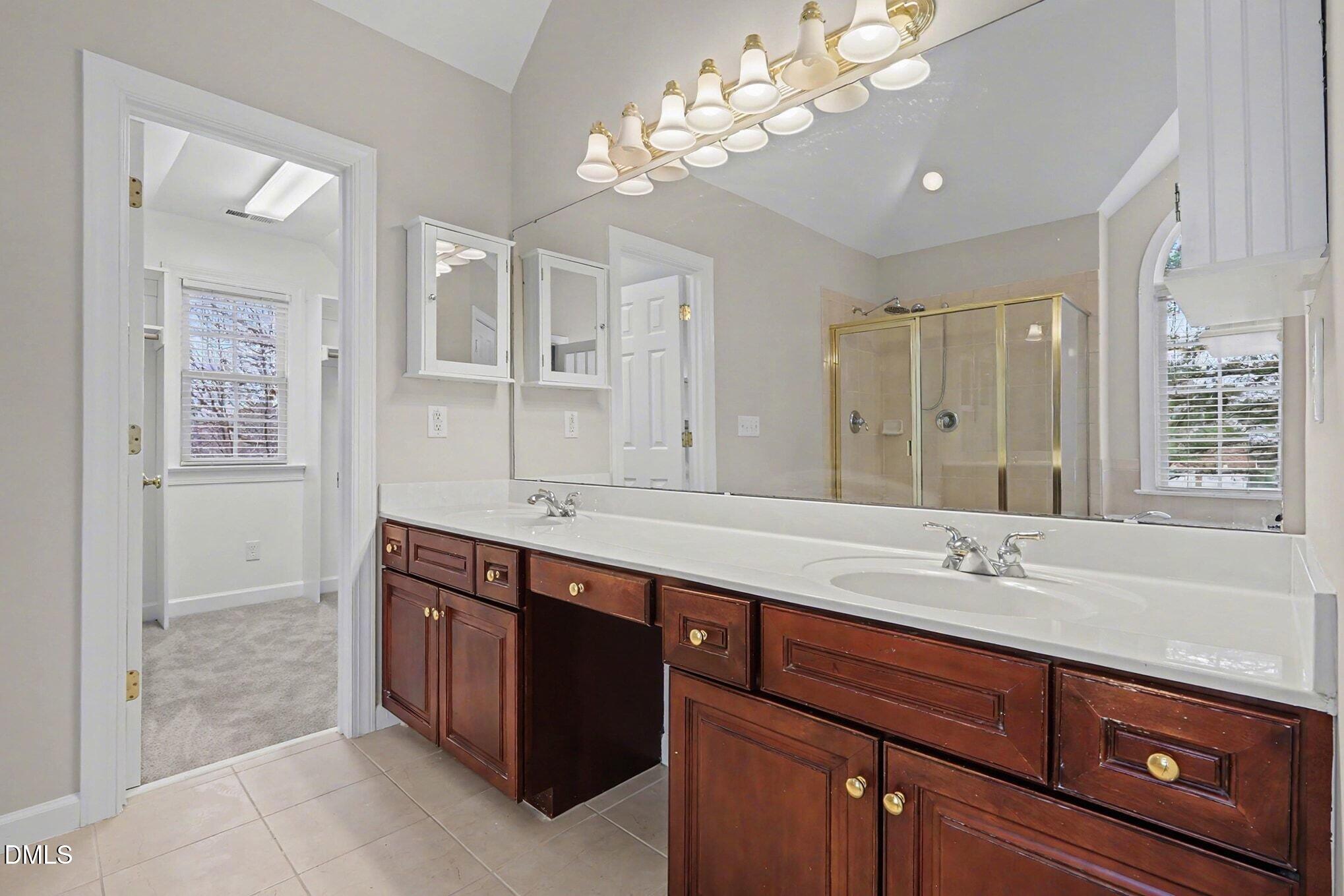 6101 Tiffield Way Wake Forest, NC 27587 - Photo 20 of 40 a bathroom with a sink double vanity and a mirror