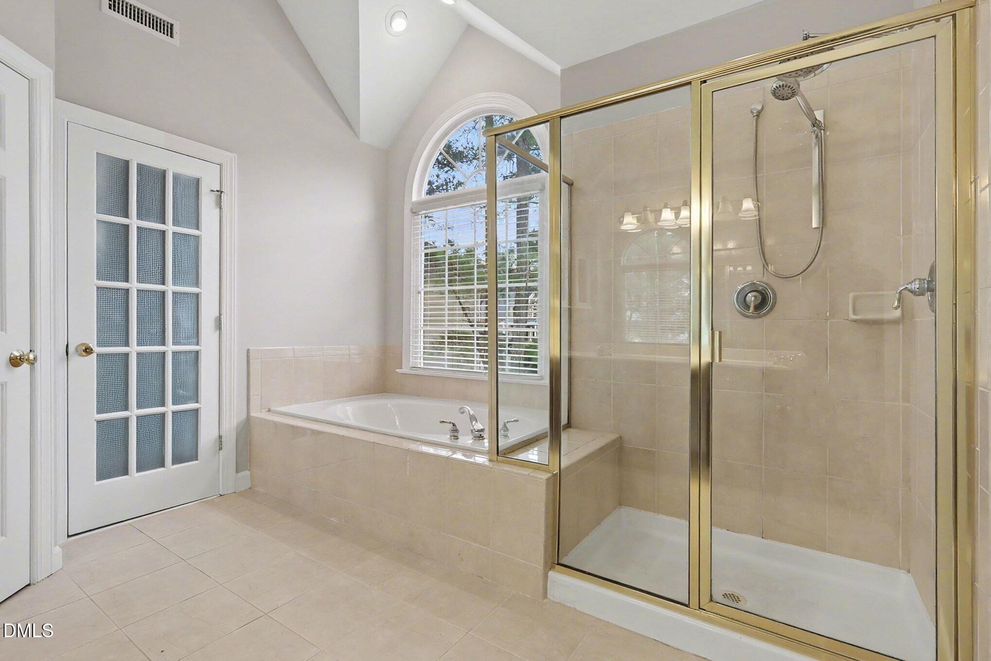 6101 Tiffield Way Wake Forest, NC 27587 - Photo 21 of 40 a bathroom with a glass shower door and a window