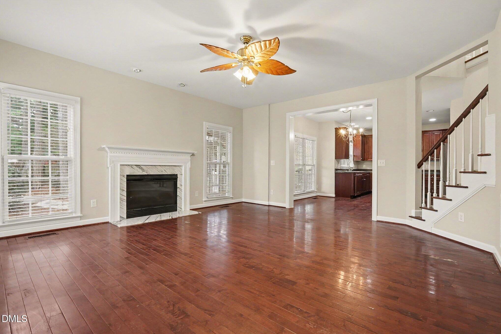6101 Tiffield Way Wake Forest, NC 27587 - Photo 9 of 40 a view of an empty room with wooden floor and a fireplace