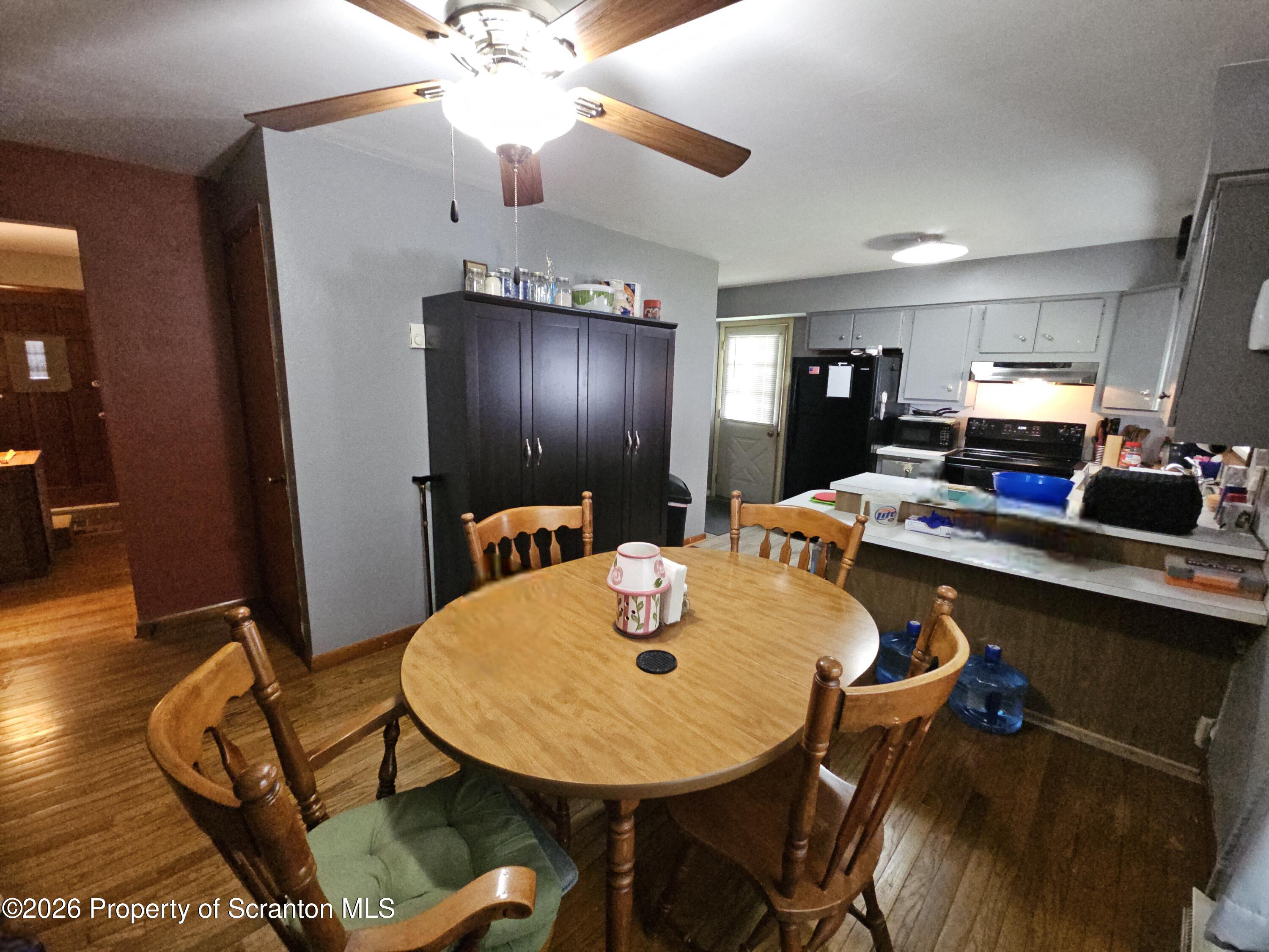 405 Baker Street Taylor, PA 18517 - Photo 12 of 36 a view of a dining room with furniture and wooden floor