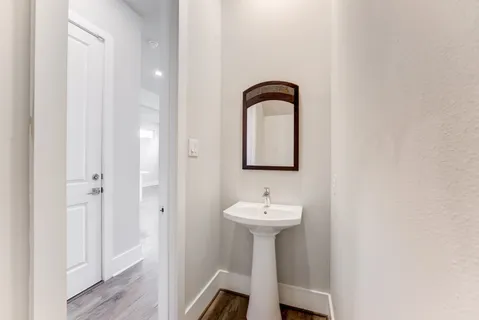 a room with a sink and mirror