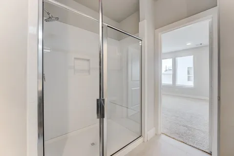 a bathroom with a glass shower door