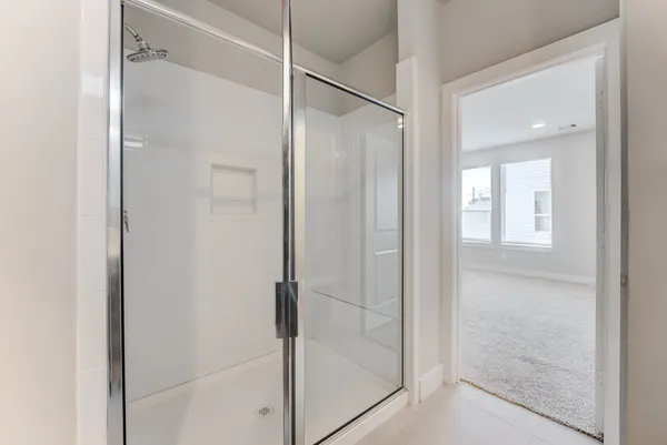 a bathroom with a glass shower door
