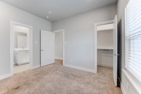 an empty room with a bathroom and a sink