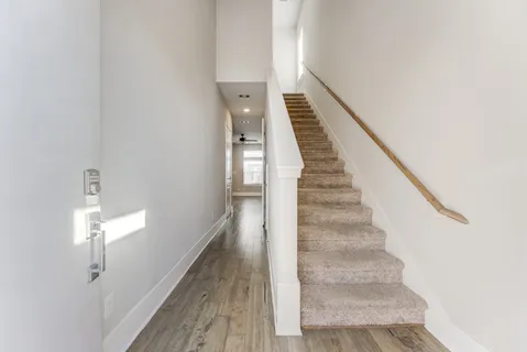 a view of entryway and hall with wooden floor