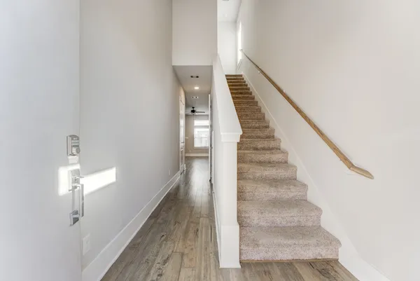 a view of entryway and hall with wooden floor
