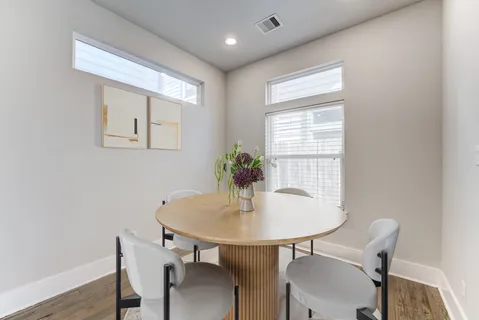 a dining room with furniture and window