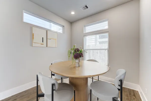 a dining room with furniture and window