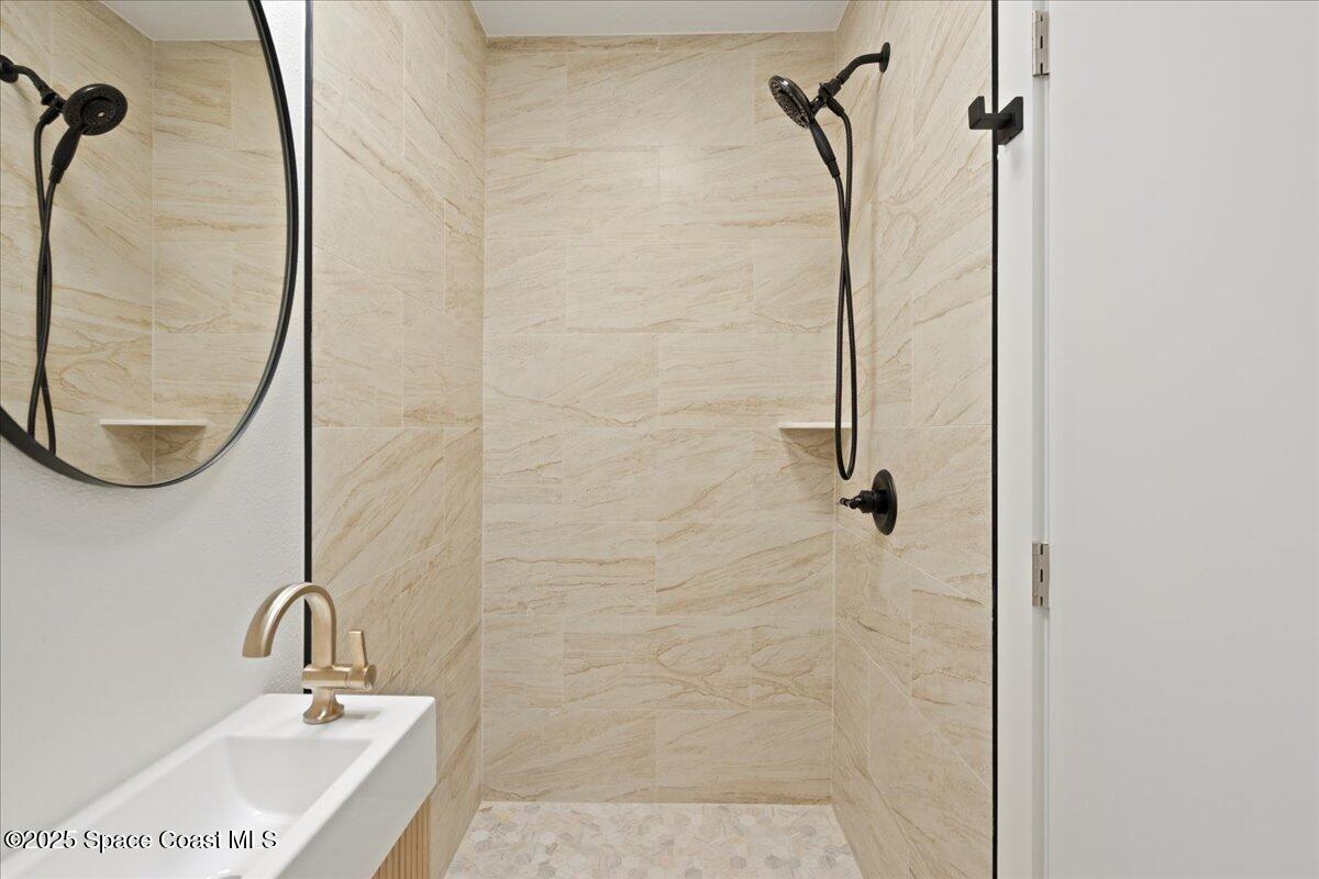 301 West Rutgers Street Melbourne, FL 32901 - Photo 11 of 36 a bathroom with a sink and a mirror